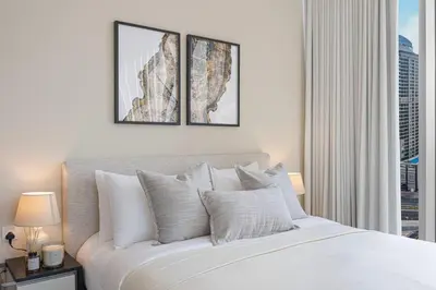 a bedroom with a white bed with a window at Daniels 2BR at Liv Marina with Marina View in Dubai