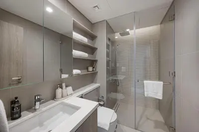 a bathroom with a shower and a sink and a toilet at Daniels 2BR at Liv Marina with Marina View in Dubai