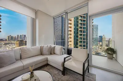 a living room with a couch and a large window at Daniels 2BR at Liv Marina with Marina View in Dubai