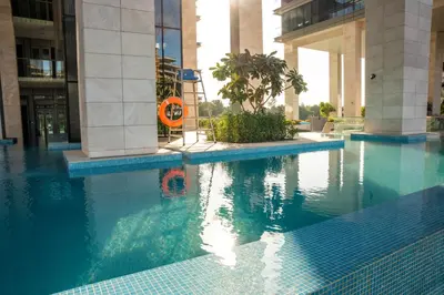 a swimming pool in the middle of a building at Luxury 1 Bedroom Canalfront Apartment with Burj Khalifa Views from Resort-Style Pool - Walk to Jumeirah Beach in Dubai