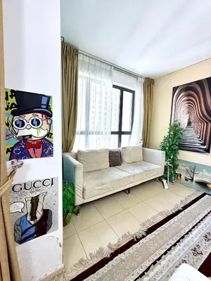 a living room with a couch and a window at WAHA WOW Bed space Available in Luxury Apartment in Sabkhah
