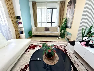 a living room with a couch and a table at WAHA WOW Bed space Available in Luxury Apartment in Sabkhah