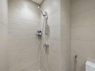 a bathroom with a shower with a glass door at Livin' Holidays - 2BR - Skyline View with Burj Glimpse in Dubai