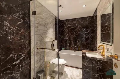 a bathroom with a sink and a toilet and a shower at Chic 1BR, Next to Metro by BMS in Dubai