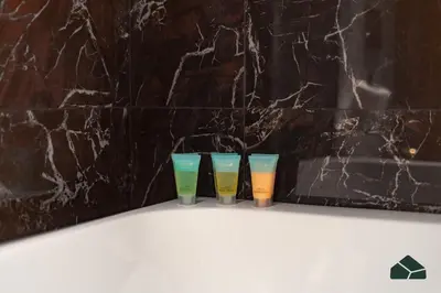 three candles in front of a black marble wall at Chic 1BR, Next to Metro by BMS in Dubai