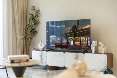 a living room with a large flat screen tv at Chic 1BR, Next to Metro by BMS in Dubai