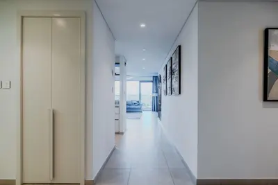a hallway with white walls and white floors at TRPS - Downtown Views II T2, Downtown Dubai - Modern 3BR Home, Maids Room, Full Burj Khalifa View in Dubai
