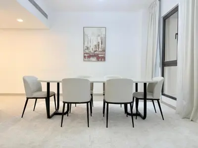 a dining room with a table and chairs at Stunning 3BR Retreat with Panoramic Sunset Views in Dubai