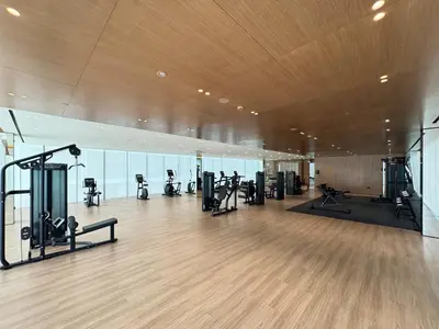 a gym with treadmills and exercise equipment in a building at Elegant 2BR Ground Floor Escape in Binghatti Galaxy JVC in Dubai