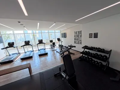 a gym with several treadmills and exercise bikes at Orange Plumeria 1701 - 2BR SeaView with Prvt Beach in Dubai