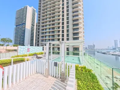 a balcony with a swimming pool and buildings at Orange Plumeria 1701 - 2BR SeaView with Prvt Beach in Dubai
