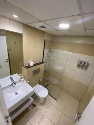 a bathroom with a sink and a toilet and a shower at Sunsand Studio at Dubai Marina in Dubai