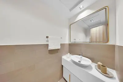 a bathroom with a sink and a mirror at 10 min to Dubai Marina - New Cozy 1 Bed in JVT in Dubai