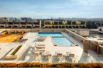 a swimming pool on the roof of a building at 10 min to Dubai Marina - New Cozy 1 Bed in JVT in Dubai