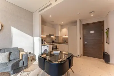 a living room with a couch and a table at HAVN - 1 bedroom in Sobha Creek, MBR City in Dubai
