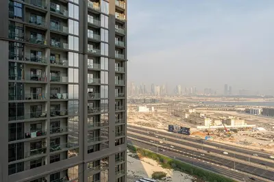 a tall building with a view of a city at HAVN - 1 bedroom in Sobha Creek, MBR City in Dubai
