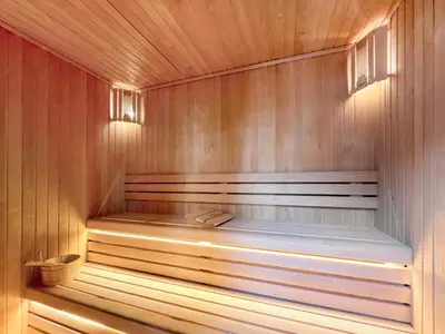 a wooden sauna with a bench in the middle at LUX 1 BDR apartment Downtown - Burj Khalifa view in Dubai