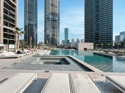 a swimming pool in a city with tall buildings at LUX 1 BDR apartment Downtown - Burj Khalifa view in Dubai