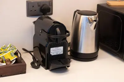 a coffee maker on a counter next to a microwave at Luxury Downtown 2 Bedroom Apartment with amazing Burj and Fountain Views and Private Jacuzzi on a large Terrace in Dubai