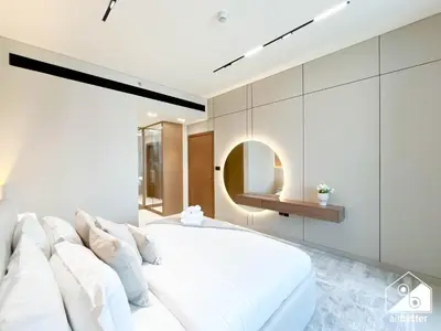 a bedroom with a large white bed with white pillows at 2BR Panoramic Skyline Haven with Jacuzzi in Dubai