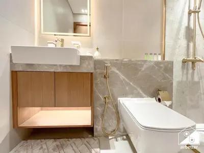 a bathroom with a sink and a toilet at 2BR Panoramic Skyline Haven with Jacuzzi in Dubai