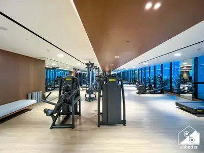 a gym with treadmills and elliptical machines at 2BR Panoramic Skyline Haven with Jacuzzi in Dubai