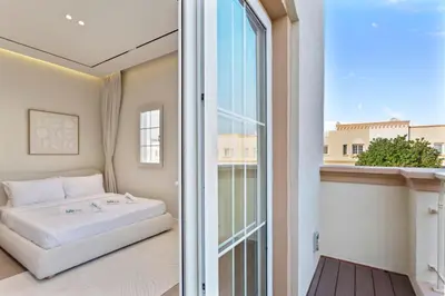 a bedroom with a bed and a large window at Cozy 2Bedroom Villa with Private Pool in Springs in Dubai