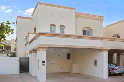 a large white house with a garage at Cozy 2Bedroom Villa with Private Pool in Springs in Dubai