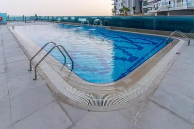 a swimming pool on a building with aicrobialicrobialicrobialicrobial at Spacious apt City view Gym and pool in Dubai