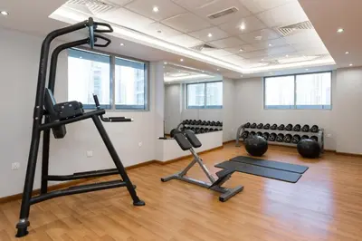 a gym with several exercise equipment in a room at Spacious apt City view Gym and pool in Dubai