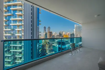 an apartment balcony with a view of the city at Spacious apt City view Gym and pool in Dubai