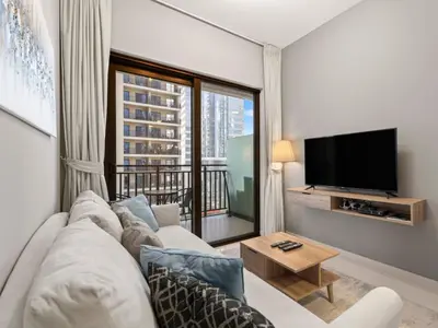 a living room with a couch and a large window at Zada Glam Sleek 1BDR Retreat-Business Bay-25 in Dubai