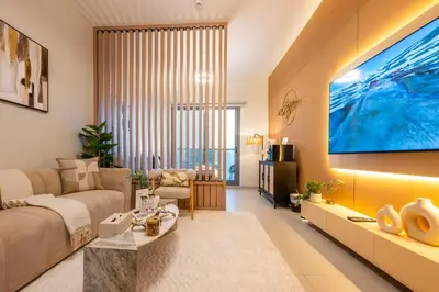 a living room with a large tv on a wall at Exquisite Studio by UDH Sway Residence at Dubai Hills in Dubai