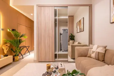 a living room with a sliding door leading to a bathroom at Exquisite Studio by UDH Sway Residence at Dubai Hills in Dubai