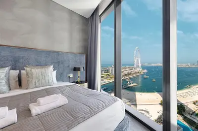 a bedroom with a large bed and a large window at Address Beach Resort 3 Bedroom with Sea and Palm Views in Dubai