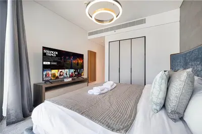 a bedroom with a bed with a flat screen tv at Address Beach Resort 3 Bedroom with Sea and Palm Views in Dubai