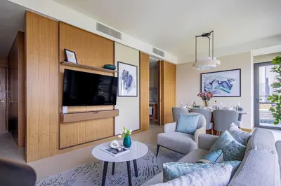 a living room with a couch and a tv at Frank Porter - Address Residences Dubai Opera Tower 1 in Dubai