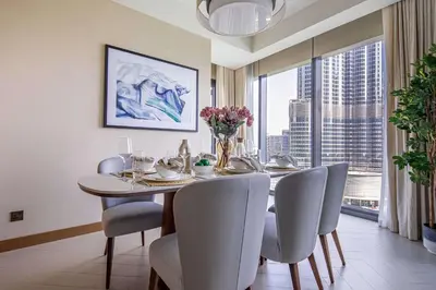 a dining room with a table and chairs and a large window at Frank Porter - Address Residences Dubai Opera Tower 1 in Dubai