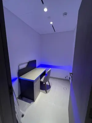 a room with a desk and a chair with a blue light at Amazing Dubai Silicon Oasis Rental Apartments in Dubai