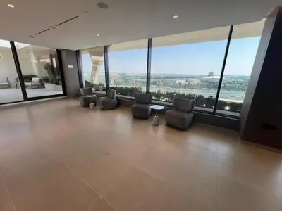 a room with chairs and a table and large windows at Amazing Dubai Silicon Oasis Rental Apartments in Dubai