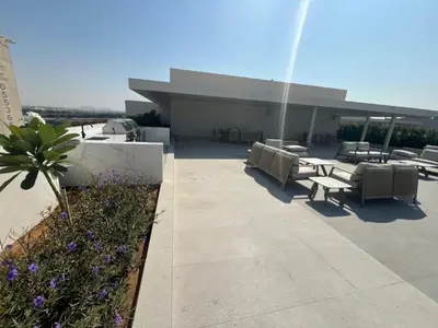 a patio with chairs and tables on a building at Amazing Dubai Silicon Oasis Rental Apartments in Dubai