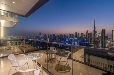 a balcony with chairs and a view of a city at BLVD - Stunning Full Burj Khalifa Firework Views in Dubai