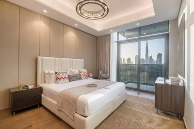 a bedroom with a large bed and a large window at BLVD - Stunning Full Burj Khalifa Firework Views in Dubai