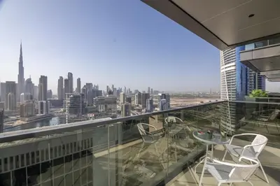 a balcony with chairs and a view of a city at BLVD - Stunning Full Burj Khalifa Firework Views in Dubai