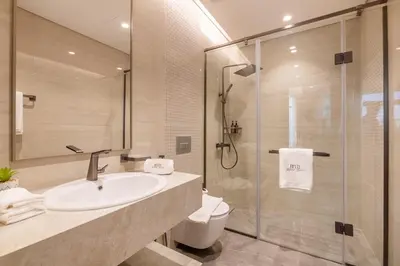 a bathroom with a sink and a glass shower at BLVD - Stunning Full Burj Khalifa Firework Views in Dubai