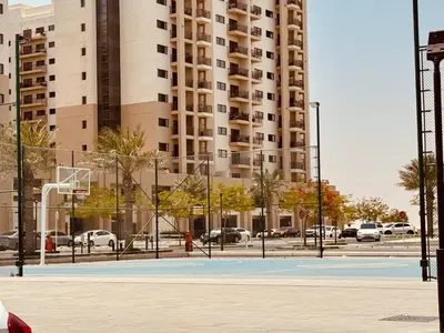 a basketball court in front of a large building at Premium Guest - Liva Serenity Suite in Dubai
