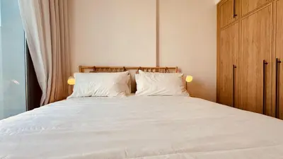 a bedroom with a large white bed with two pillows at Premium Guest - Liva Serenity Suite in Dubai