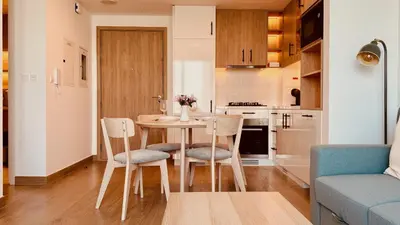 a kitchen and dining room with a table and chairs at Premium Guest - Liva Serenity Suite in Dubai