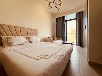 a bedroom with a large bed with a large window at Premium Guest - Dubai Riviera in Dubai