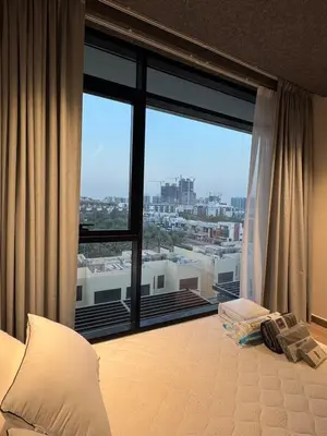 a bedroom with a large window with a view at Peaceful Modern Home Overlooking JVC Green Park in Dubai